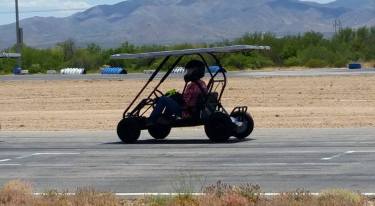 Team Member, Sara S., races around the track in one of the CAS team's go karts